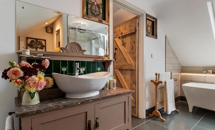 mable top washstand with period art *** tiles, matching stained glass, LED lighting over bath, traditional towel rail wooden cottage door